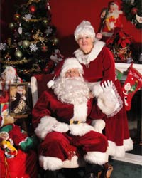 velvet mrs santa claus suit with santa sitting