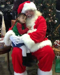 santa claus picture 2016 sitting with child